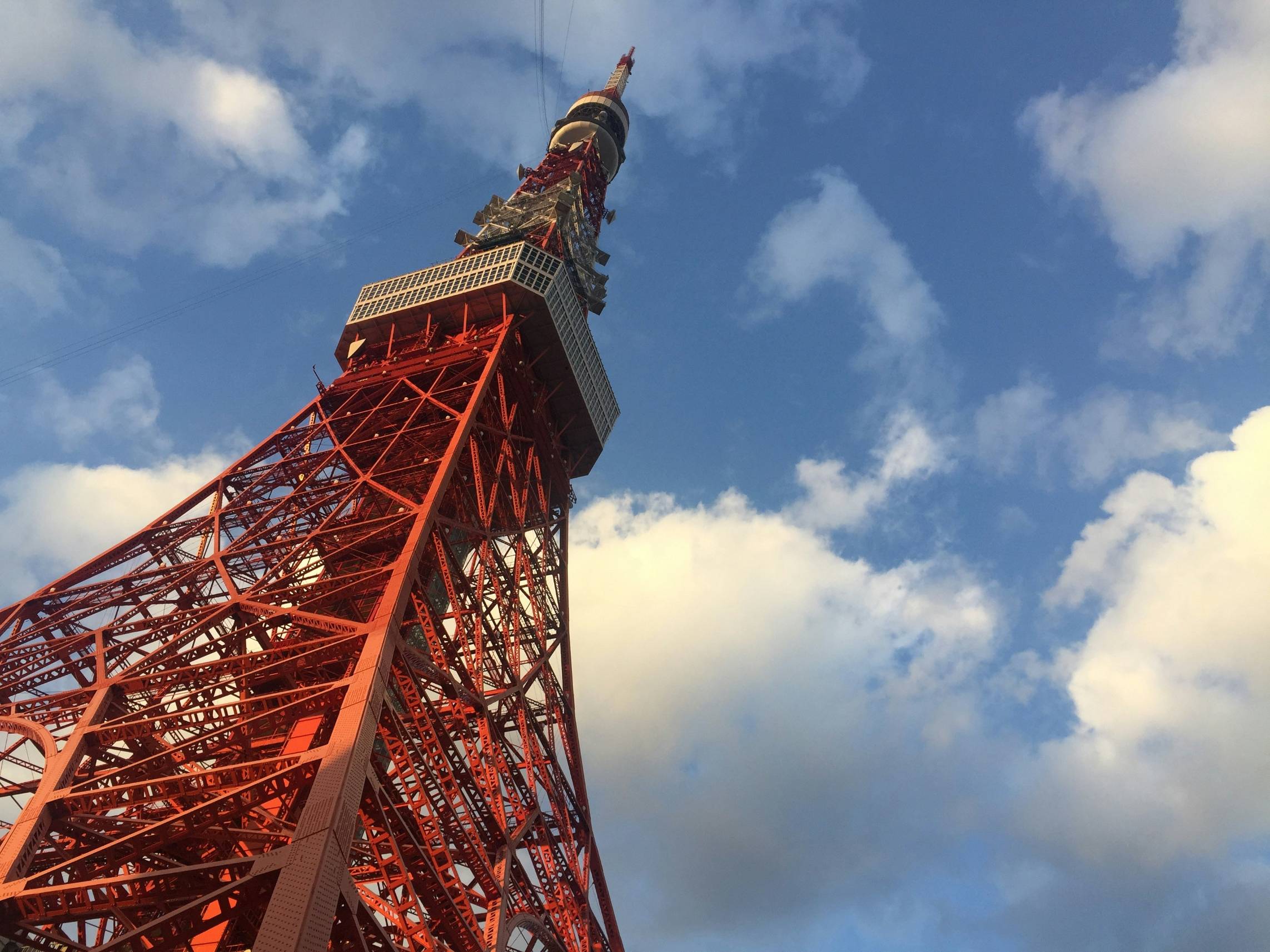 a very tall red tower with a sky background