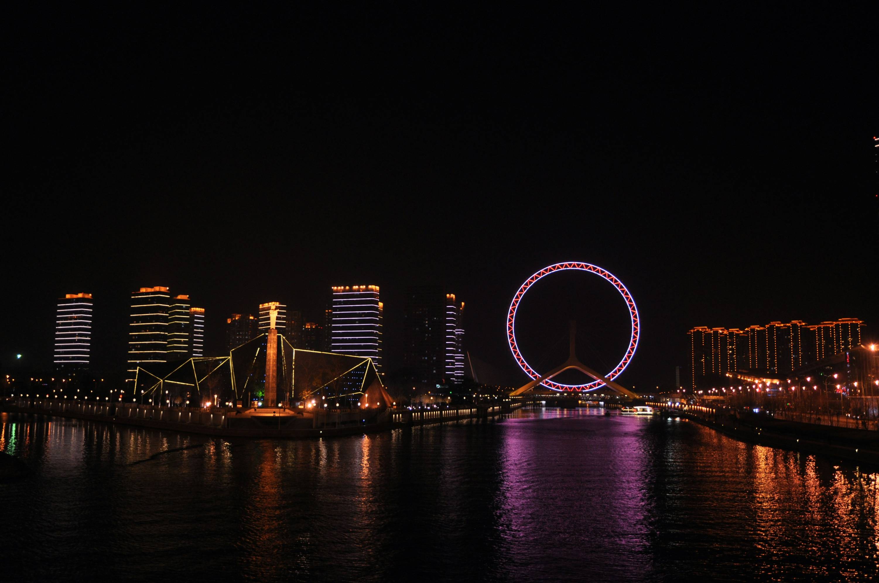 city and ferris wheel with lights during nighttime