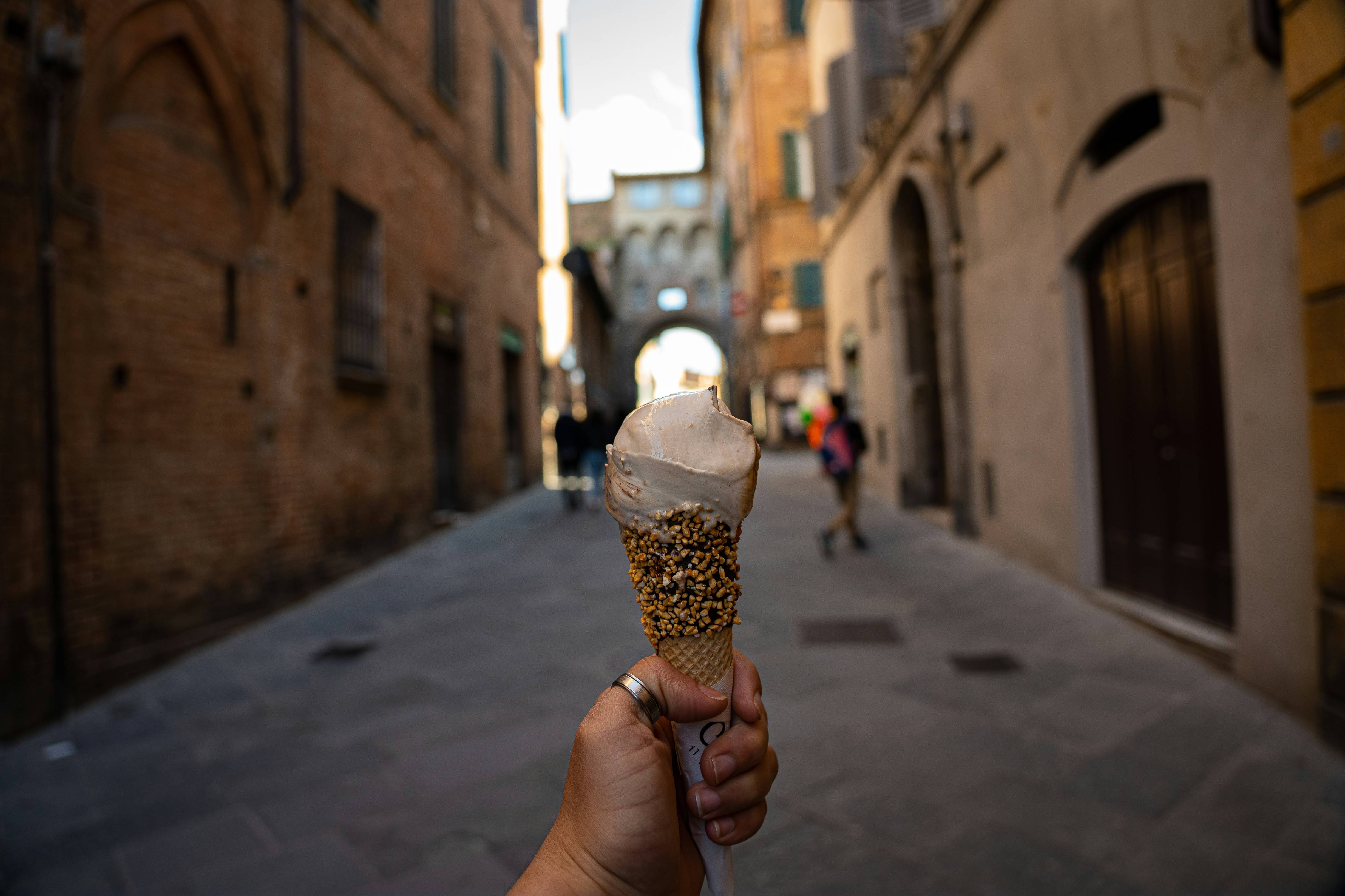 a hand holding an ice cream cone