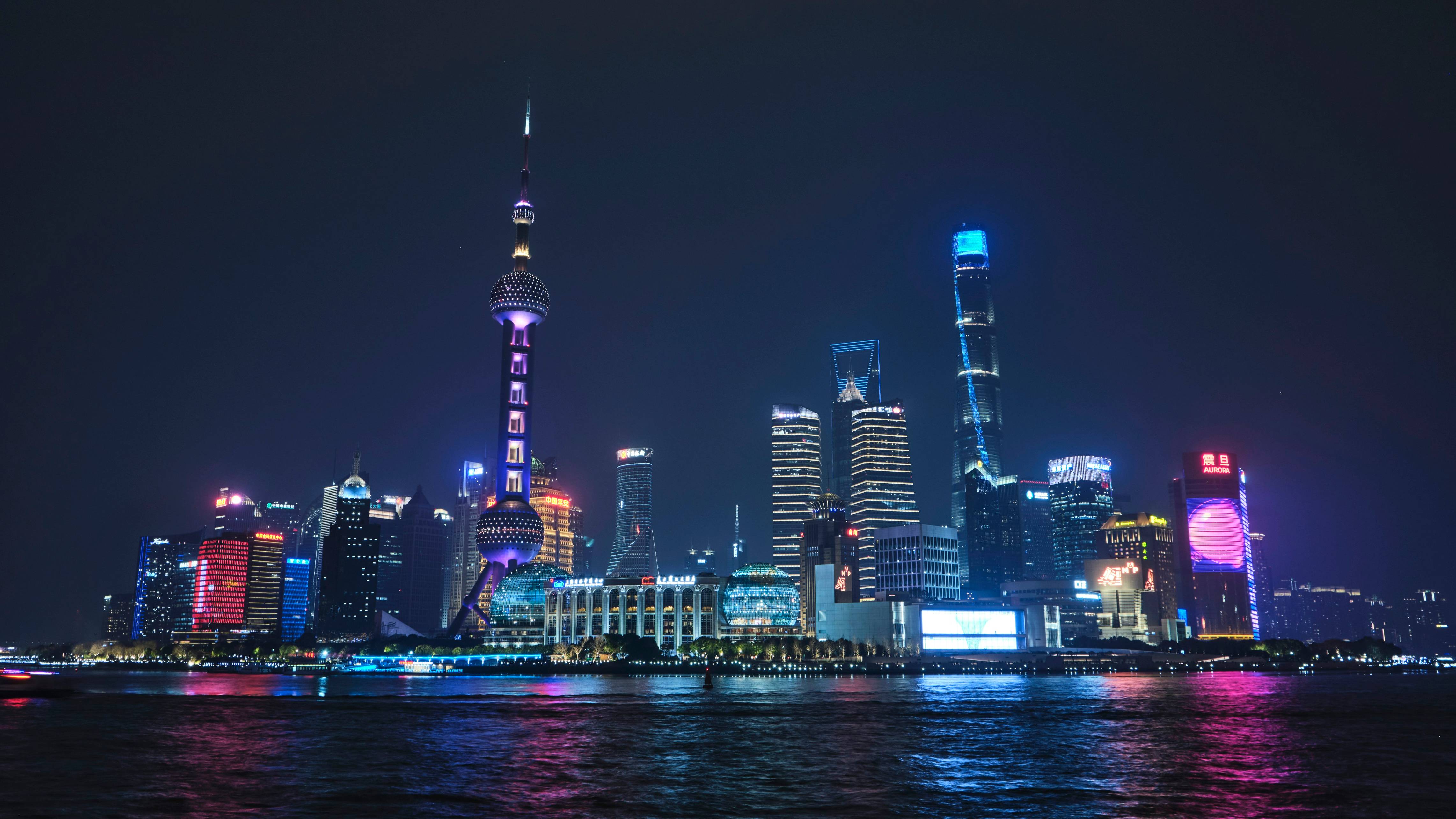 a city at night with a lot of tall buildings