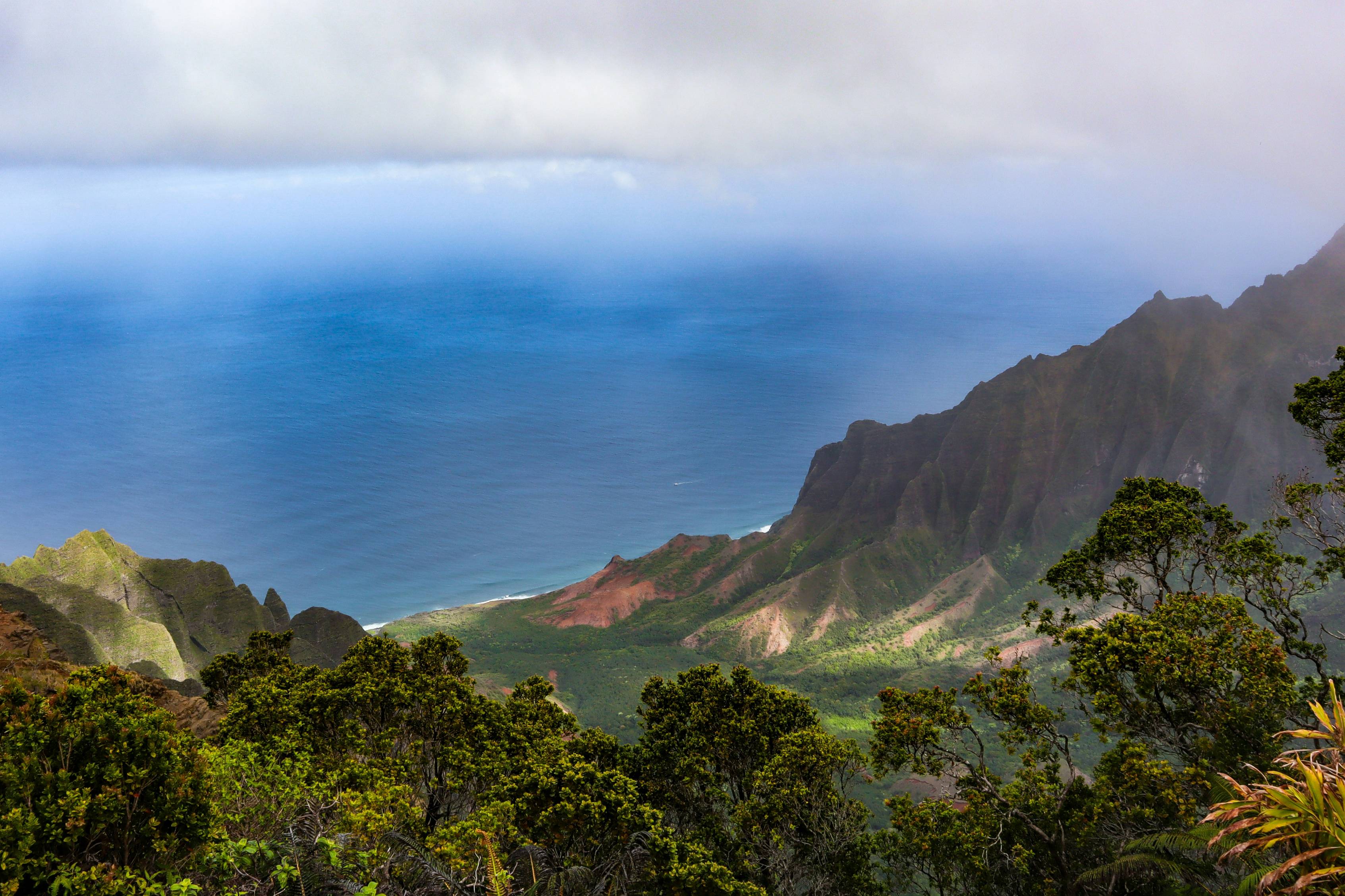 A view of a mountain range with a body of water in the distance