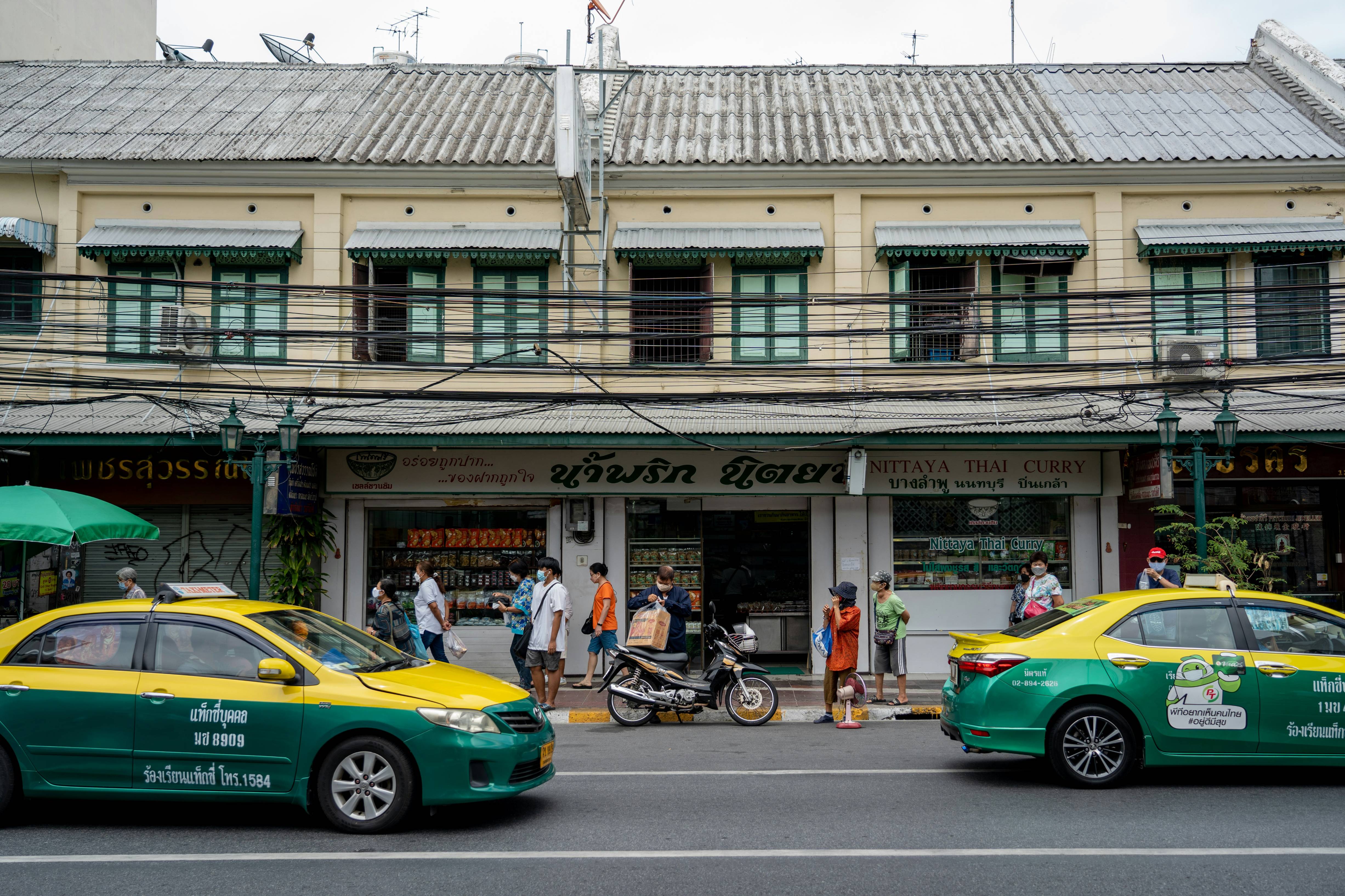 a street with cars and people