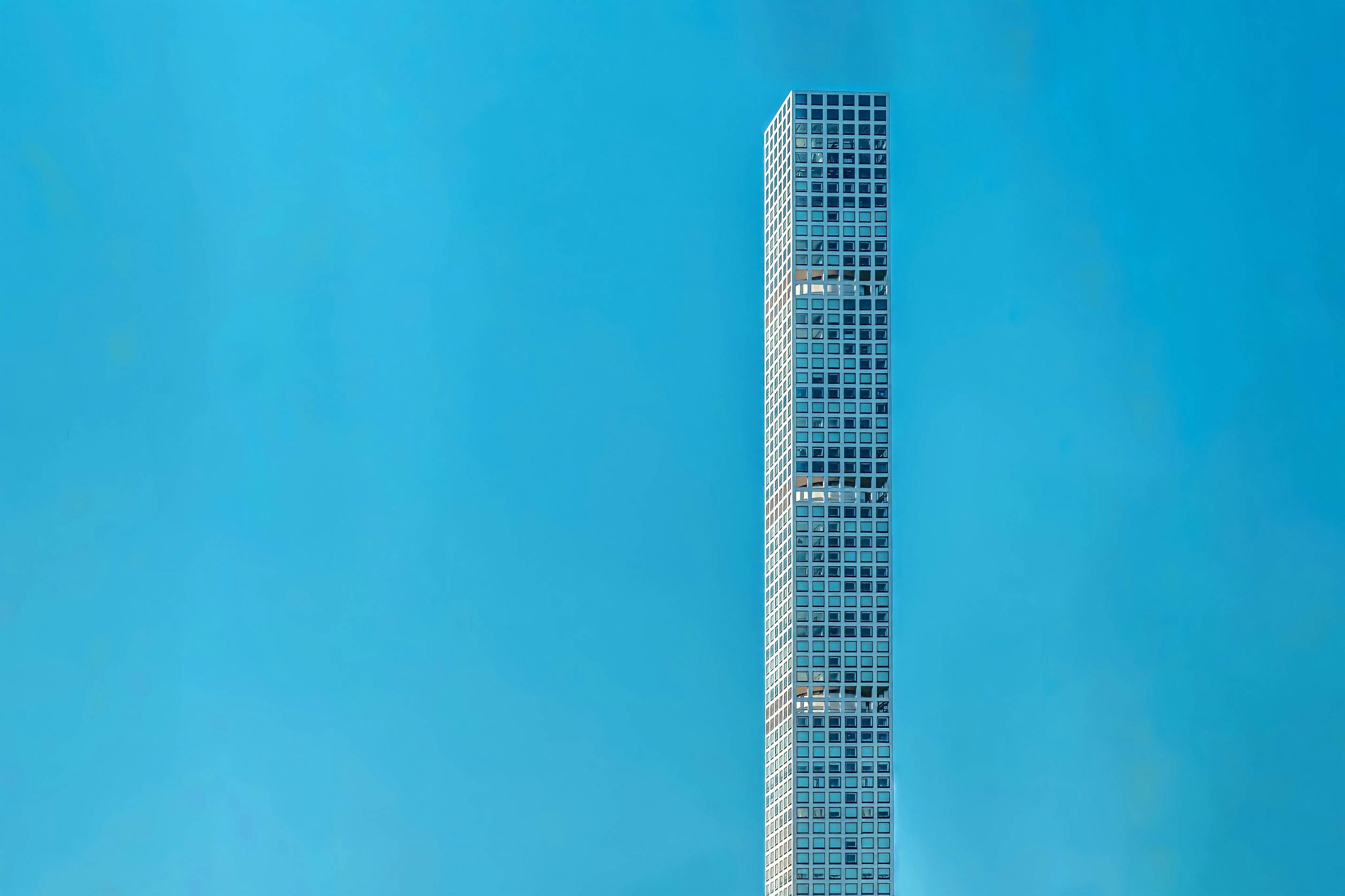 blue and white high rise building under blue sky during daytime