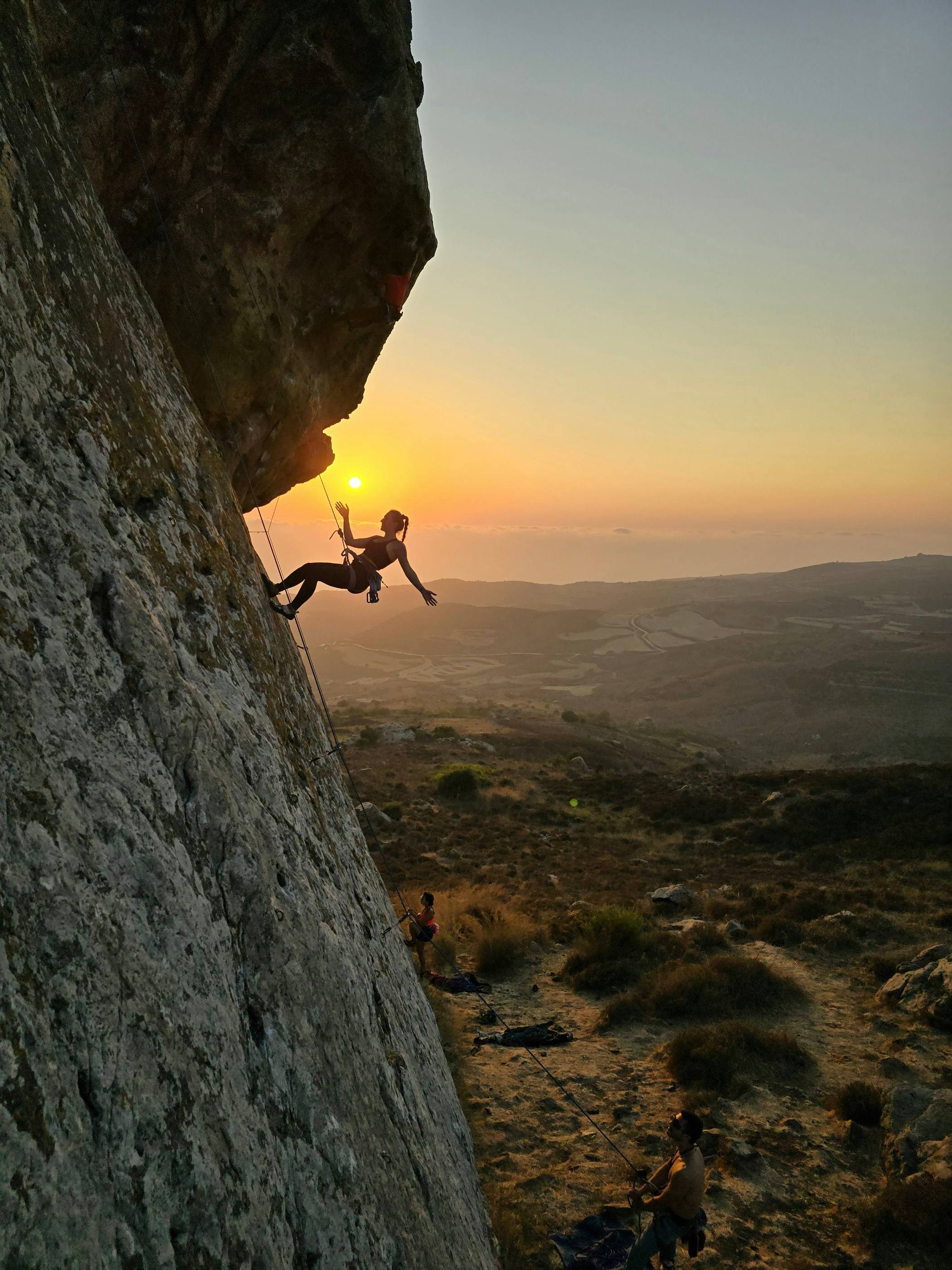 A man climbing up the side of a mountain