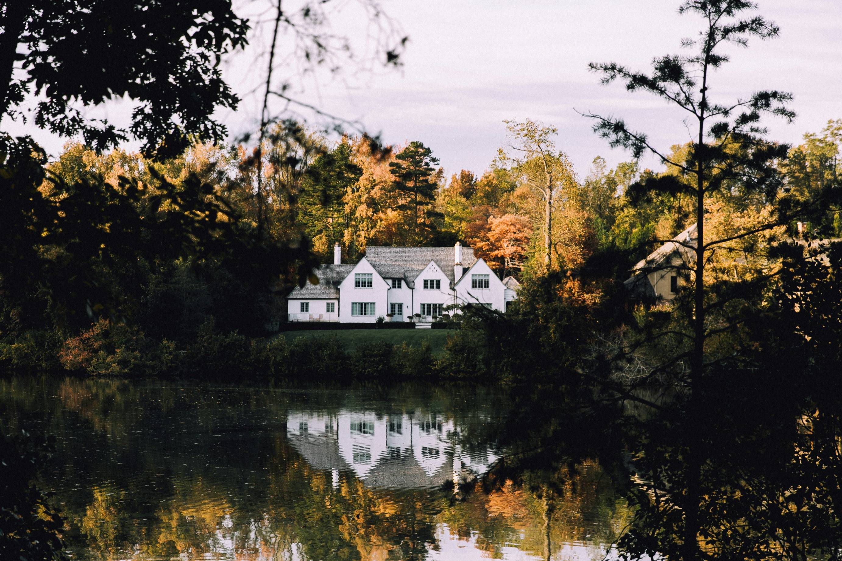 white concrete house near river