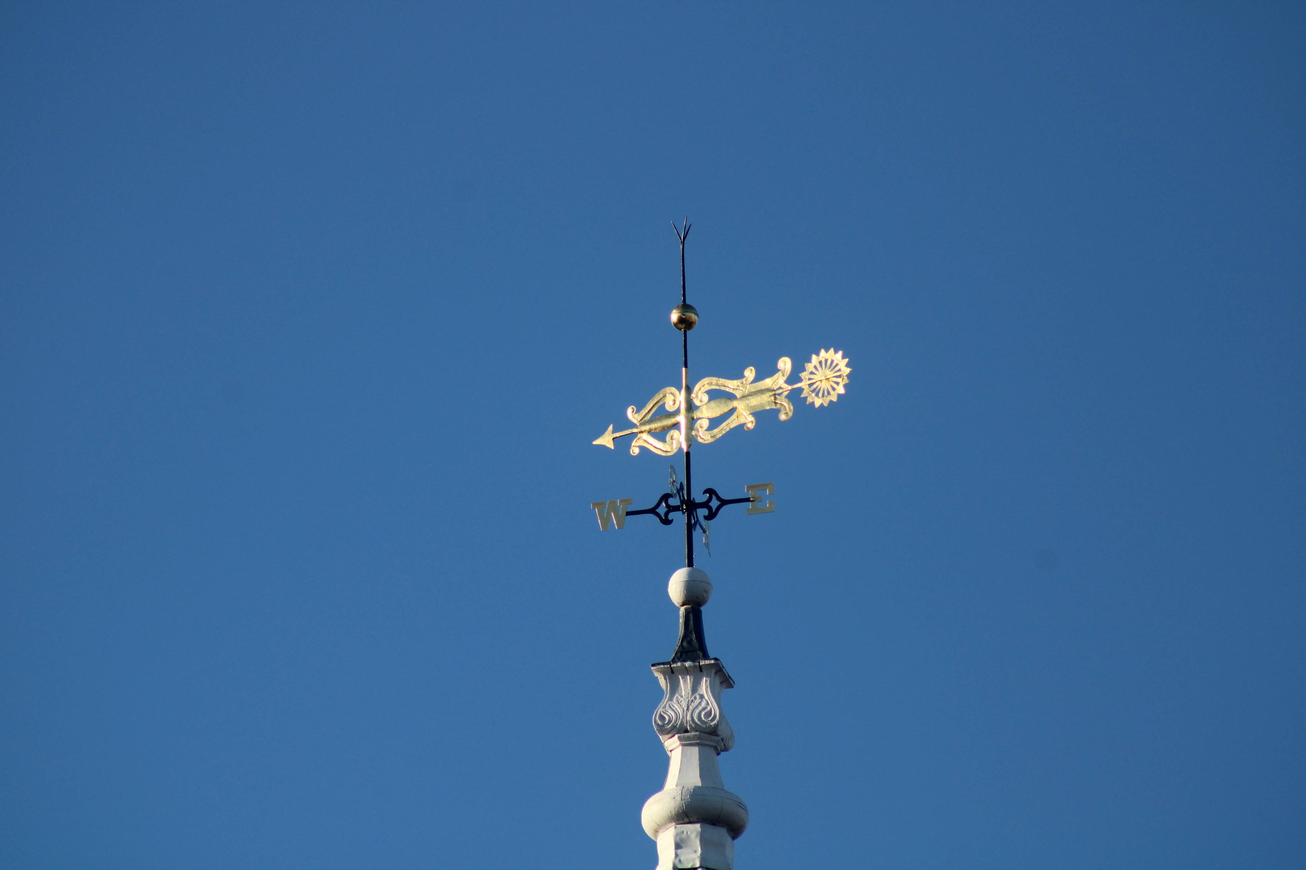 a weather vane on top of a building