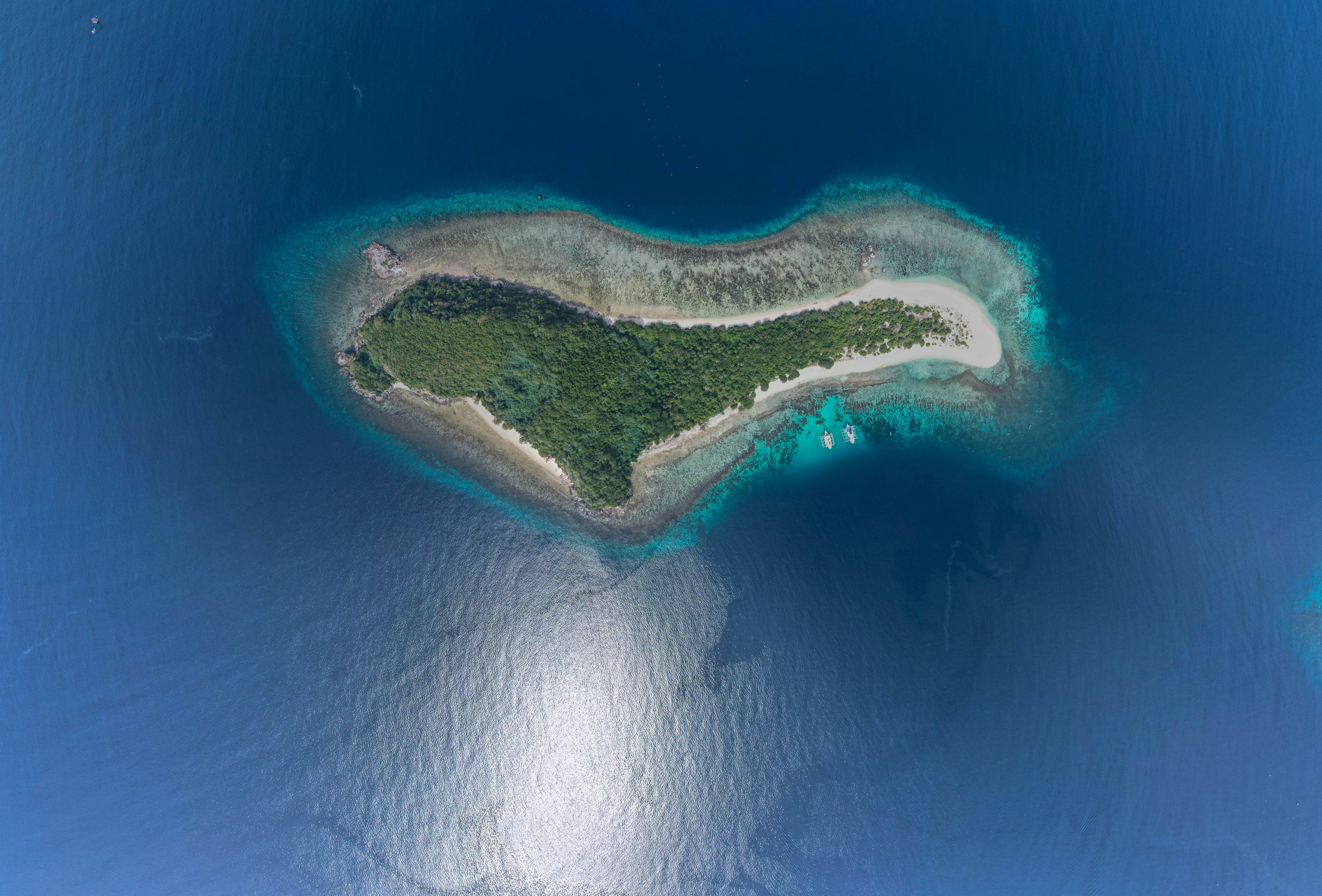Aerial view of a heart-shaped island surrounded by blue ocean.